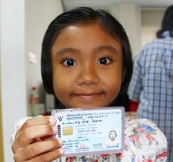 7-year-old Sarocha Pachaporn smiles after receiving her first ID card.